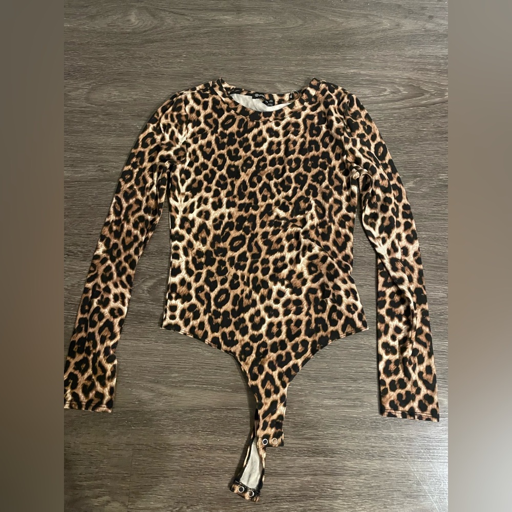 Cheetah print bodysuit, long sleeve. Very soft! Size medium.